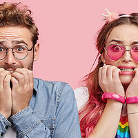 row of men and women looking panicked and nervous with colourful clothing on biting their nails